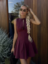 A Sleeveless Dress Decorated With A Bow